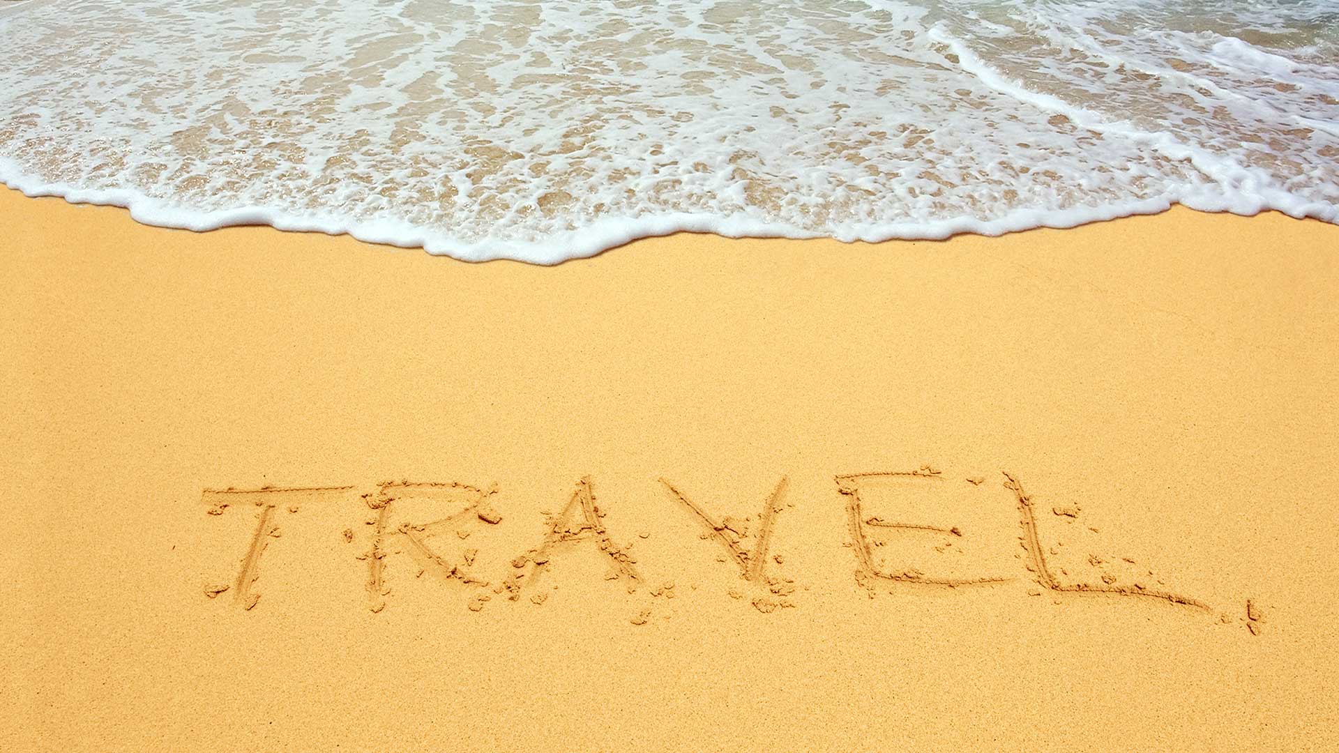 Travel sign on the beach